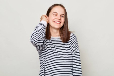 Photo for Happy face. Positive emotions. Smiling attractive cheerful brown haired woman wearing striped shirt posing isolated over gray background - Royalty Free Image