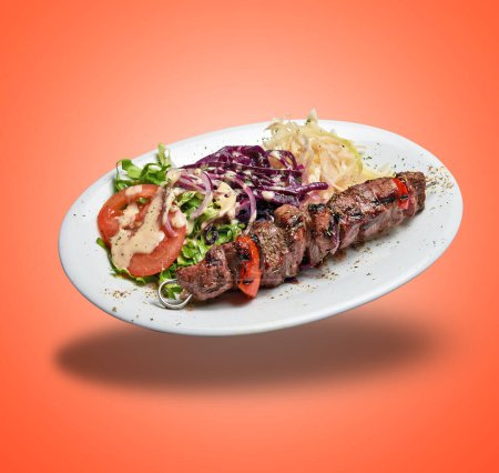 Photo for Floating White plate with Lamb skewer and salad on orange gradient background - Royalty Free Image