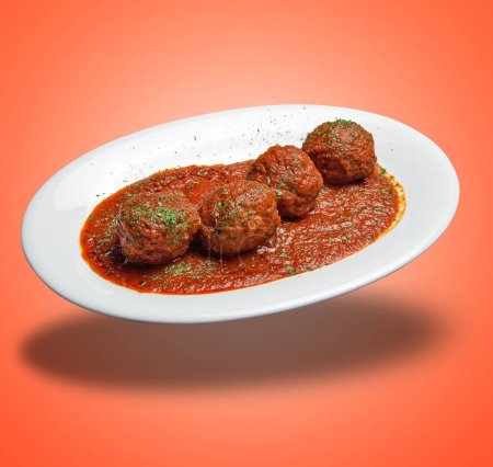 Photo for Floating White plate with Beef meats balls and tomato sausage on orange gradient background - Royalty Free Image