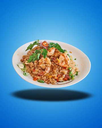 Photo for Floating Fried Rice and Shrimp on white Plate on blue gradient background - Royalty Free Image