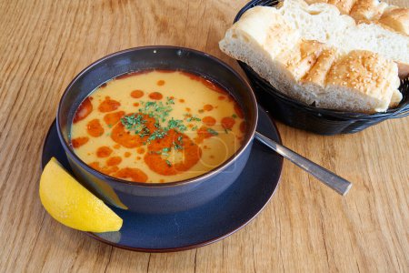 Lentil or tripe soup on wooden textured table