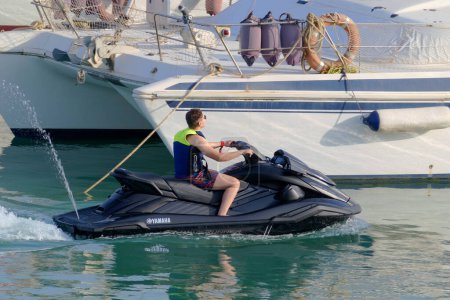 Photo for Italy, Sicily, Marina di Ragusa (Ragusa Province), 16 July 2023, man on a jet ski in the port - EDITORIAL - Royalty Free Image