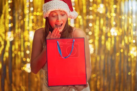 Photo for Young woman with shopping bags over gold background. High quality photo - Royalty Free Image