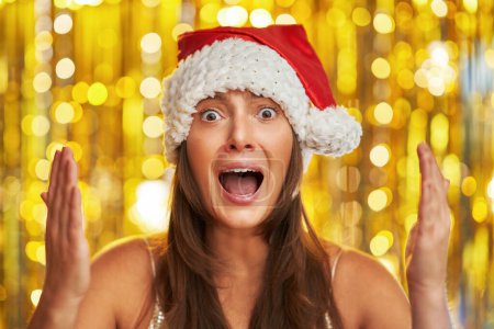 Photo for Woman over gold background making funny faces. High quality photo - Royalty Free Image