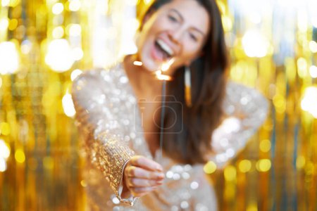 Photo for Young woman holding sparkle over gold background. High quality photo - Royalty Free Image
