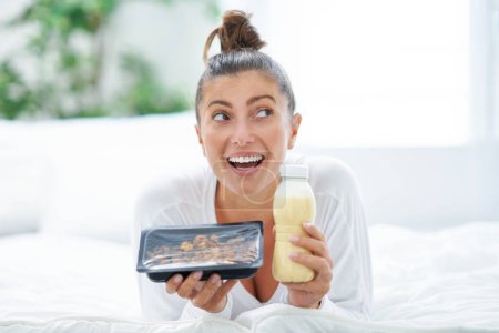 Photo for Young woman on bed with food catering. High quality photo - Royalty Free Image