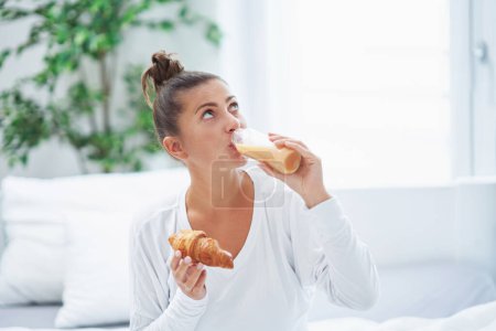 Photo for Young woman on bed with food catering. High quality photo - Royalty Free Image