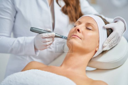 Woman in a beauty salon having needle mesotherapy treatment. High quality photo
