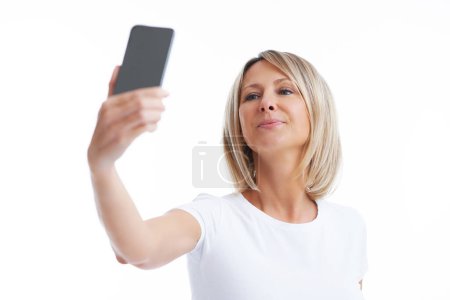 Foto de Picture of blonde woman over back isolated background with mobile phone. High quality photo - Imagen libre de derechos