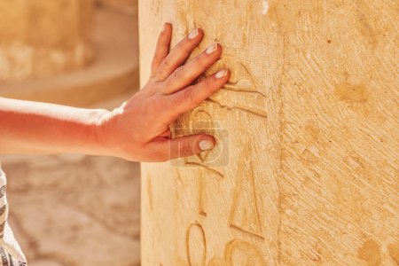Photo for Image of hand touching Egyptian hieroglyphs in Mortuary Temple of Hatshepsut. High quality photo - Royalty Free Image