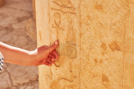 Photo for Image of hand touching Egyptian hieroglyphs in Mortuary Temple of Hatshepsut. High quality photo - Royalty Free Image