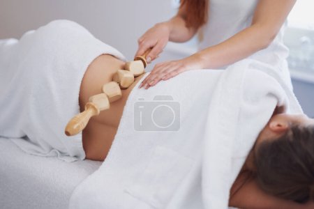 Woman at massage therapy with wooden tools. High quality photo