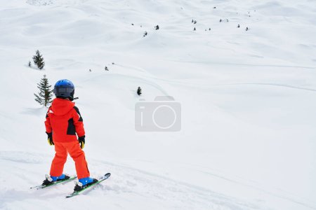 Picture of happy boy in skies Madonna di Campiglio. High quality photo