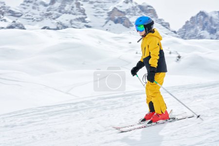 Picture of happy boy in skies Madonna di Campiglio. High quality photo
