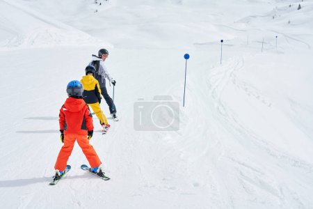 Photo for Picture of mother teach skiing her kids in Madonna di Campiglio. High quality photo - Royalty Free Image