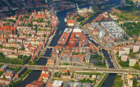 A breathtaking aerial view showcases a vibrant European city with rivers, bridges, and a dense urban landscape