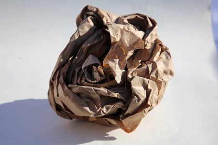Photo for Paper. Rolled Up Brown Paper. Crumpled brown paper bag. Shipping and Packing Paper. close up. crumpled brown ball. Recycling - Royalty Free Image