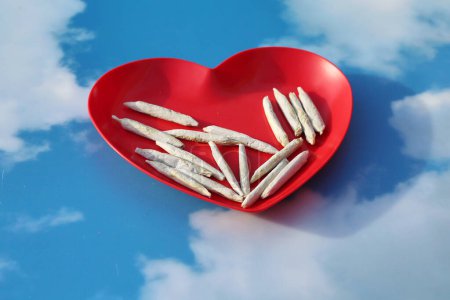 Photo for Marijuana. Cannabis. Medical Marijuana. Marijuana Joints with  Fresh Buds in heartshaped plate - Royalty Free Image