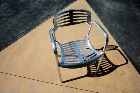 Téléchargez les photos : Chair. Patio Furniture. Aluminum Chair  on a Patio. Restaurant Chair. Outdoor seating. Metal Furniture for relaxing and dining. - en image libre de droit
