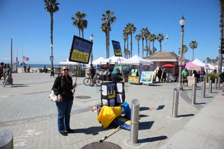 Photo for Huntington Beach, California - USA - March 6, 2022: People protesting the war in Ukraine. People gather in to protest Russia declaring war against Ukraine and the unfair and unjust war. - Royalty Free Image