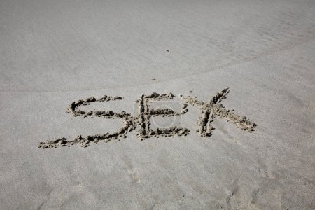 Photo for Sex written in the sand on the beach.  message handwritten on a smooth sand beach - Royalty Free Image