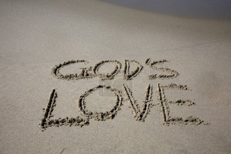 Photo for God's love written in the sand on the beach.  message handwritten on a smooth sand beach - Royalty Free Image