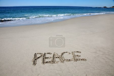 Photo for Peace written in the sand on the beach.  message handwritten on a smooth sand beach - Royalty Free Image