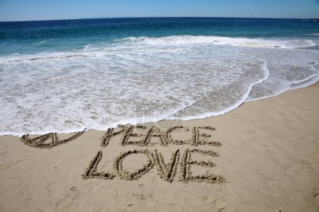 Photo for Peace love written in the sand on the beach.  message handwritten on a smooth sand beach - Royalty Free Image
