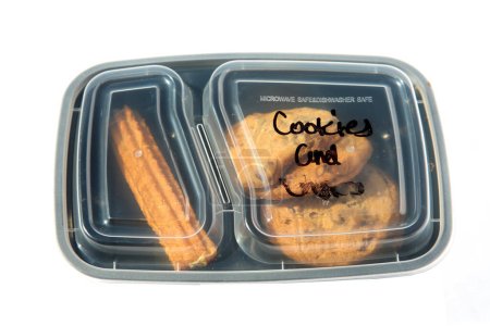 Foto de Cookies and Churros. Chocolate Chip Cookies. Mexican Churros. Restaurant Food to Go. Food Delivery. Lunch. Dinner. Packaged Food to go. Isolated on white. Room for text. Lunch Time. - Imagen libre de derechos