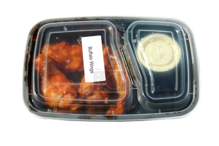 Foto de Buffalo Wings. Chicken Wings. Hot Wings. Restaurant Food to Go. Food Delivery. Lunch. Dinner. Packaged Food to go. Isolated on white. Room for text. Lunch Time. - Imagen libre de derechos