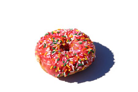 Foto de Donut. Pink Donut with Rainbow Sprinkles. Isolated on white.  Donut in pink glaze with colored sprinkles. - Imagen libre de derechos