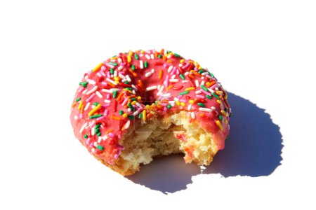 Foto de Donut. Pink Donut with Rainbow Sprinkles. Isolated on white.  Donut in pink glaze with colored sprinkles. - Imagen libre de derechos