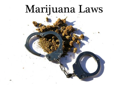 Foto de Marijuana laws. Cannabis. Marijuana and the Law. Legal Cannabis Use. Cannabis and Handcuffs. - Imagen libre de derechos