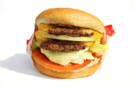 Téléchargez les photos : Lake Forest, Californie - États-Unis 25 février 2023. Burgers in-n-out. Double double hamburger au fromage. Isolé sur blanc. De la place pour le texte. Burgers au fromage sont appréciés dans le monde entier par les gens pour le déjeuner et le dîner. - en image libre de droit