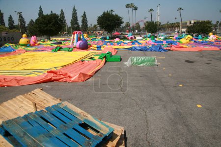 Photo for Buena Park, California - USA - April - 27-2023: Inflatable toys in a parking lot. uninflated inflatable blow-up toys for kids. colorful inflatable children party castles, slides, and bounce houses. - Royalty Free Image