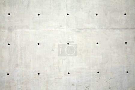 Photo for Background. Cement Wall with holes. Background of a smooth Cement Wall with many holes spaced evenly apart. Backgrounds and Textures. Room for text or images. The Perfect background for all your needs - Royalty Free Image
