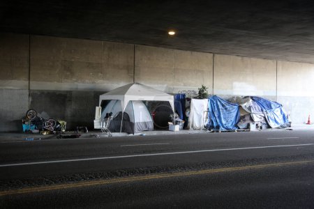 Photo for Long Beach, California - USA - April 16, 2023: Homeless Shelter against a wall in a traffic lane. Homelessness has become a national problem for society and the people effected by poverty. - Royalty Free Image