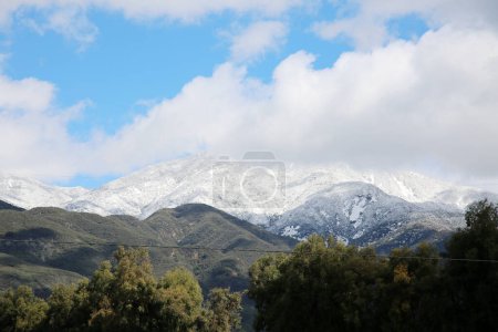 Photo for Saddle Back Mountain with snow. Rancho Santa Margarita, California. February 26, 2023 Rare View of Snow on Saddle Back Mountain in Orange County California. A cold winter storm covers Saddleback. - Royalty Free Image