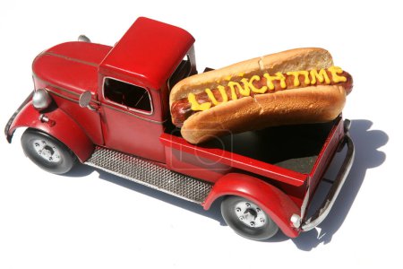 Photo for Hotdog. Hot Dog. Hot-Dog with the words HOT DOG written in Yellow Mustard. Hotdogs for Lunch. Hot dog with the words "Hot Dog" in yellow mustard. Isolated on white. HotDog in a red truck in its bun. - Royalty Free Image