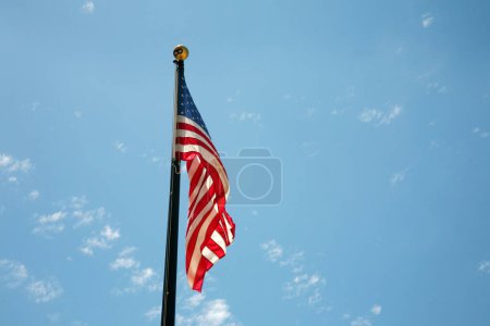 Photo for American Flag. American Flag Waving in the breeze for Memorial Day. US Flag for the 4th of July holiday. American flag fluttering in the breeze with a Blue Sky background. USA. Stars and Stripes. - Royalty Free Image