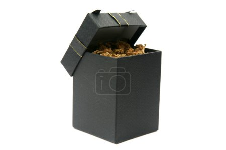 Photo for Marijuana. Cannabis. A Gift Box filled with Cannabis Sativa. Black Gift Box with Cannabis Indica. Room for text. - Royalty Free Image