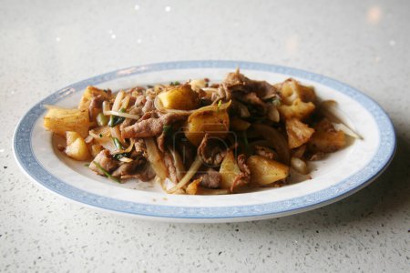 Photo for Mongolian Barbecue. Mongolian barbecue is a stir-fried dish that was developed in Taiwan during 1950s. Despite its name, the dish is not Mongolian. Pork with Pineapple and white Onions and White Rice. - Royalty Free Image