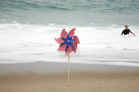 Photo for American Flag. An American Flag Pin in the breeze on the beach. American flag on the beach in the sand. - Royalty Free Image