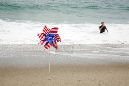 Photo for American Flag. An American Flag Pin in the breeze on the beach. American flag on the beach in the sand. - Royalty Free Image