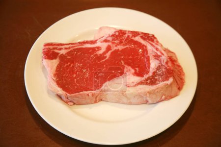Photo for Steak. Beef Steak. Red Meat. Juicy medium Beef Rib Eye steak. Raw meat close up - Royalty Free Image