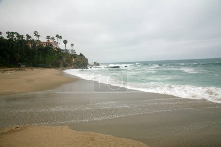 Photo for Laguna Beach, California - USA - May 18 2023: ALISO BEACH PARK Aliso Beach Park. Waves wash up on shore in Laguna Beach California. Aliso park in Laguna is a inviting location to relax all day. - Royalty Free Image