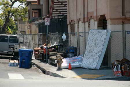 Photo for Long Beach, California - USA - April 16, 2023: Homeless Shelter against a wall in a traffic lane. Homelessness has become a national problem for society and the people effected by poverty. - Royalty Free Image