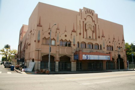 Photo for Los Angeles. California - USA - May 18, 2023: Abandoned movie theater turned into a Church and locked closed with a fence and locks. Homeless can set up on the side of the building. Crisis in the USA - Royalty Free Image
