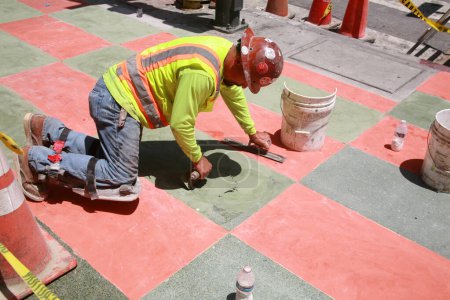 Photo for Los Angeles. California - USA - May 18, 2023: Sidewalk. Contractors install and detail a Gray and Red Sidewalk in Los Angeles California. Masons who work with cement and stone complete a custom job. - Royalty Free Image