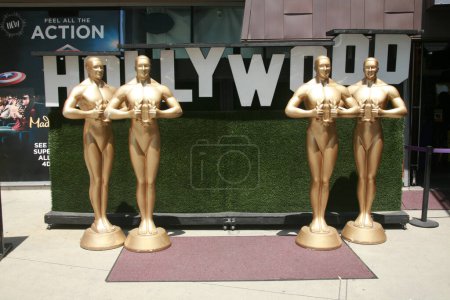 Foto de Hollywood, California, EE.UU. - 12 de mayo de 2023: La estatua del Oscar. Turista disfrutar Posando con tamaño natural Oscar estatuas para fotos. Premio al Mérito de la Academia. Estatua de Oscar de fama mundial para posar por diversión. - Imagen libre de derechos